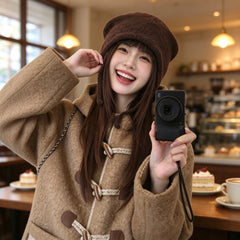 Girl laughing in a cafe wearing the coffee cat ear beanie with ties