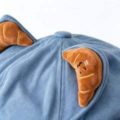 Close-up of the plush croissant ear on light blue denim