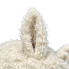 Close-up of the tall fuzzy ear on the cream plush cap