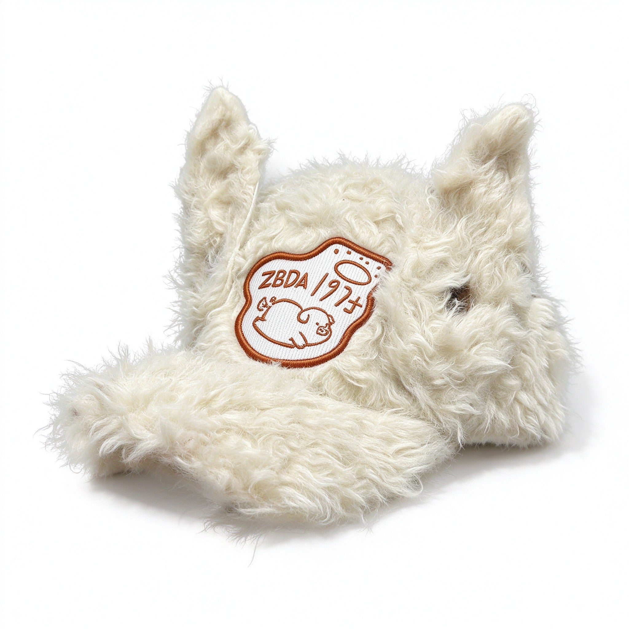 Cream fuzzy plush baseball cap with tall upright ears and embroidered pig patch