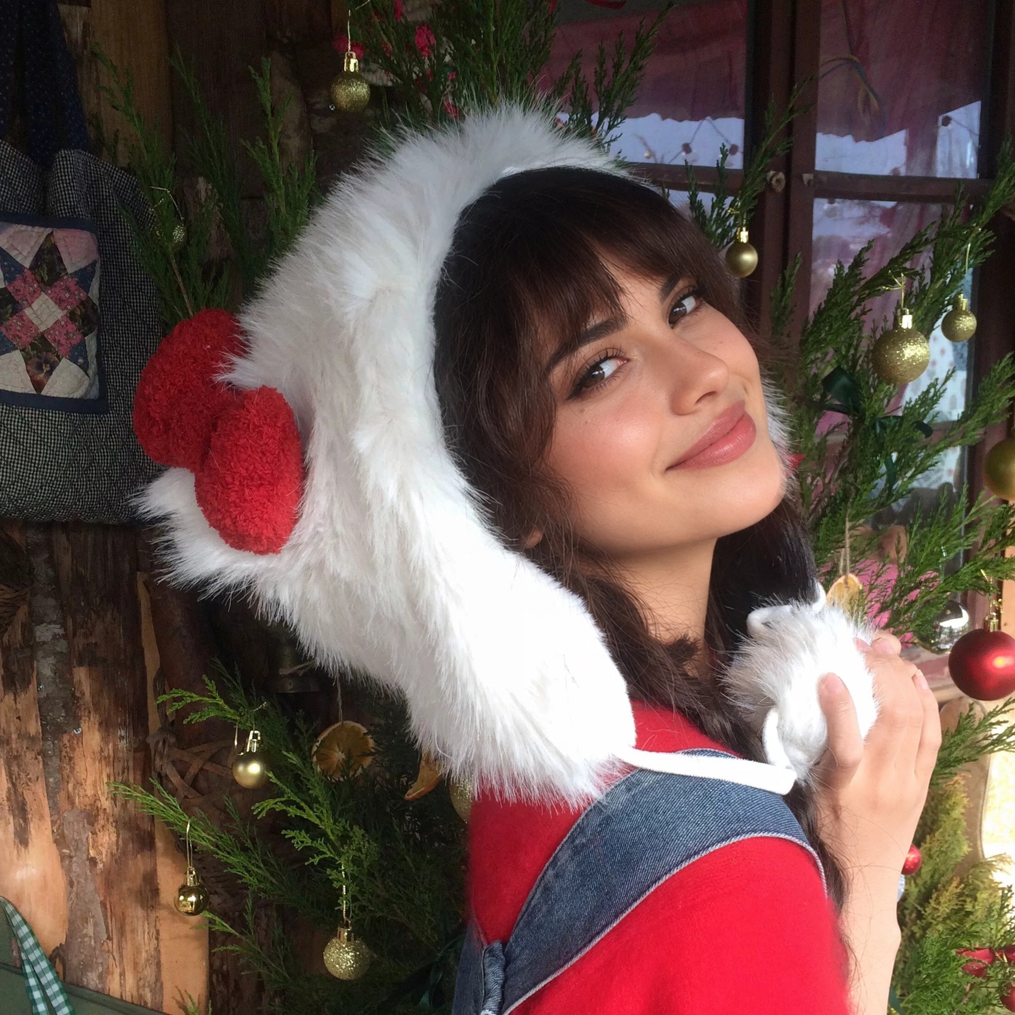 Fluffy Ear-Flap Winter Hat with Red Bow & Pompom Ties in white, side view showing the ear flap