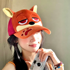 Plush fox baseball cap with embroidered eyes, nose, paw print, and 3D fox ears in soft velvety fabric.